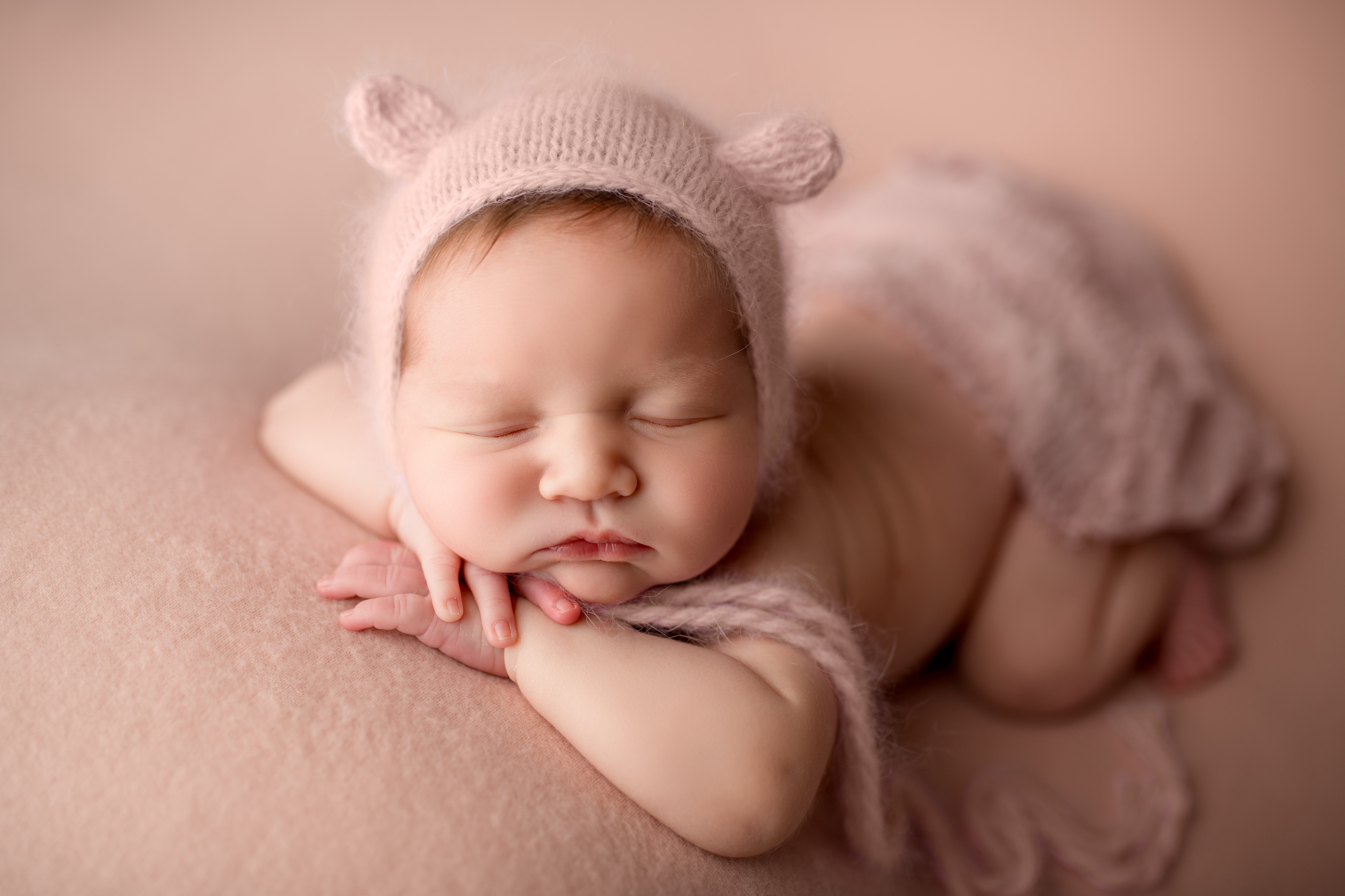 newborn in pink teddy bonnet taken in Erie Pennsylvania by Maria Angeles Photography
