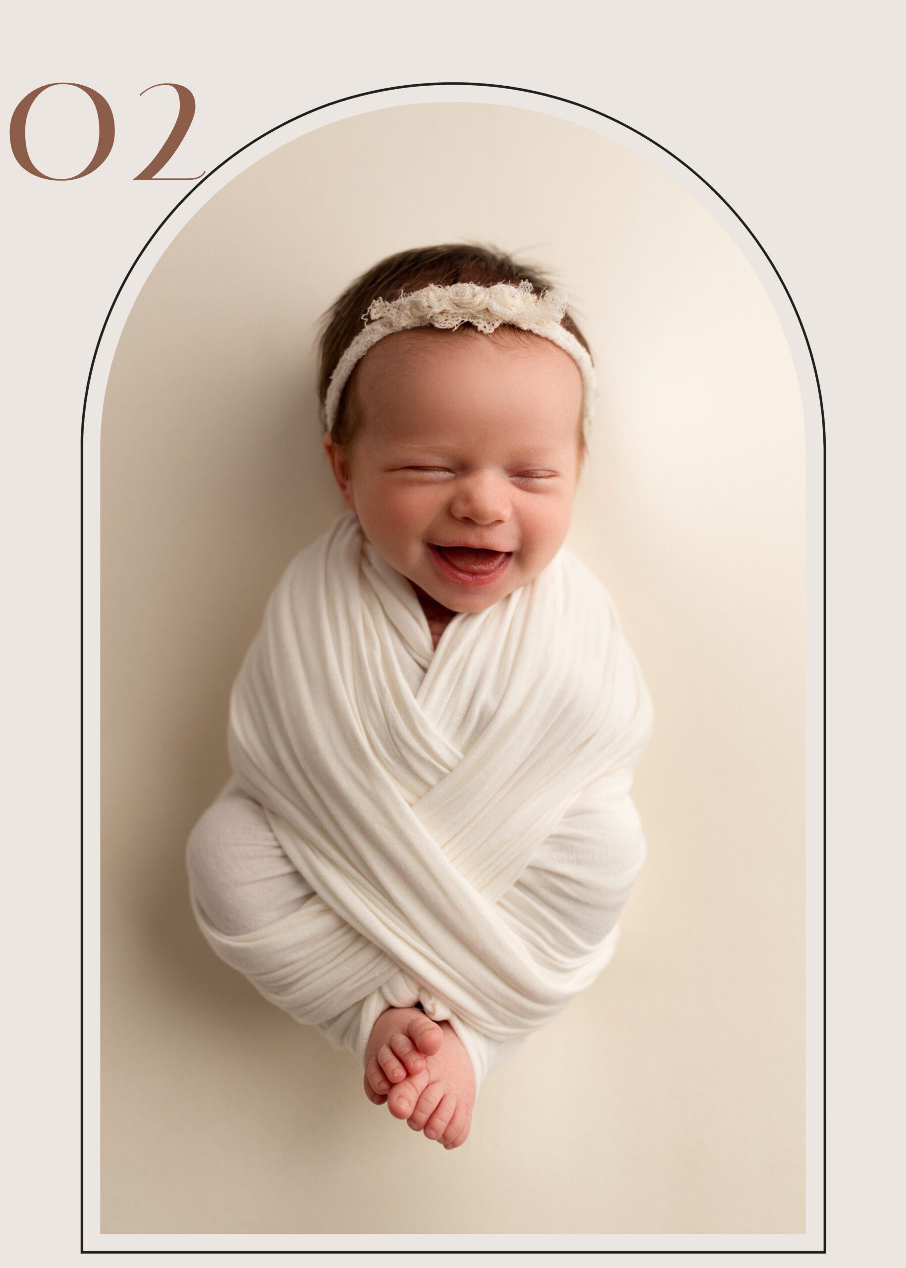 Newborn photography session in Erie PA featuring smiling baby wrapped in neutral swaddle with lace headband.